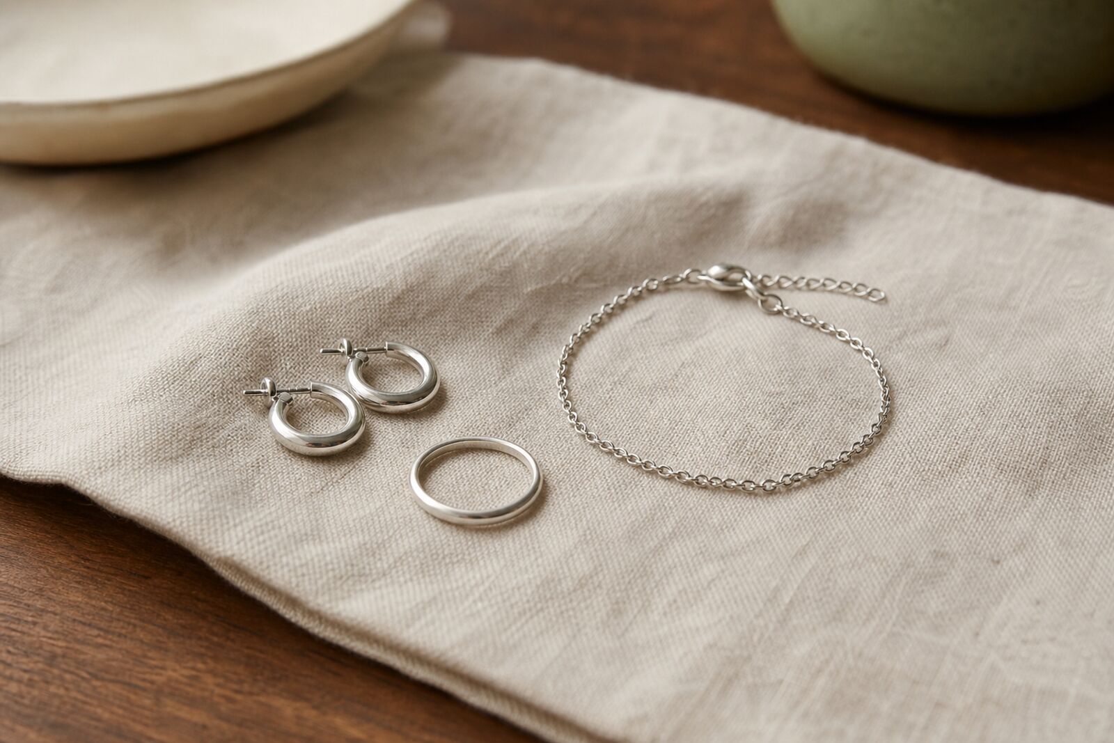A few simple sterling silver and steel pieces arranged on a linen cloth
